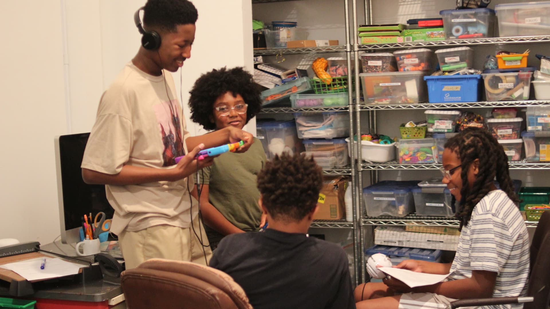 Junior Producers sharing a mic and scripts during a workshop session